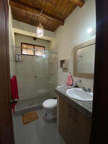 a bathroom with a sink and a toilet and a shower at Olon de Haciendas Olonche in Olón