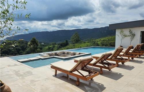 a group of chairs and a swimming pool at Serrano Exclusive in Tiradentes