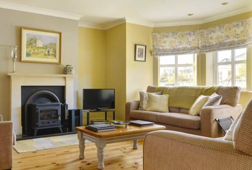 a living room with a couch and a fireplace at 18 Ard na Mara in Dingle