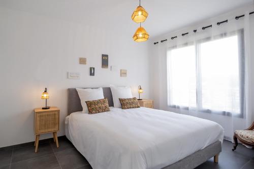 - une chambre blanche avec un grand lit blanc et 2 oreillers dans l'établissement Flaubert 16 - Domaine d'Arca - 4 pers - étage 1, à Porto-Vecchio