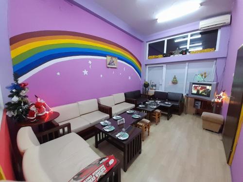 a living room with a rainbow painted on the wall at Sunshine in Gevgelija