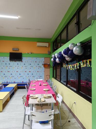 a dining room with a table with a pink tablecloth at Sunshine in Gevgelija
