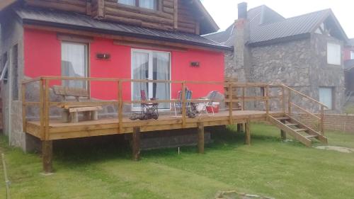 a large wooden deck in front of a house at La Andyna Caviahue in Caviahue