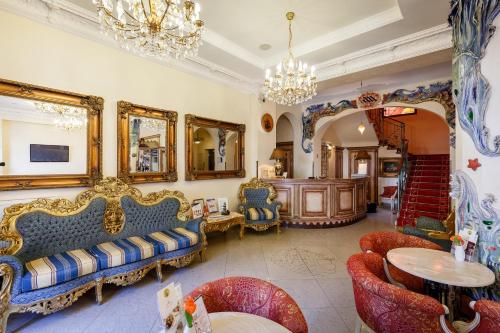 a living room filled with furniture and a chandelier at Aqua Marina in Karlovy Vary