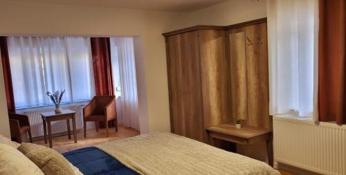 1 dormitorio con 1 cama, 1 silla y 1 mesa en Gästehaus Da Fabio, en Bad Bocklet