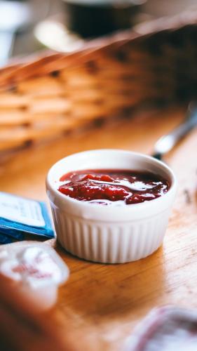 a white bowl of sauce on a wooden table at Quinta da Bocaina in Amparo