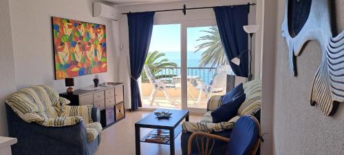 a living room with two chairs and a view of the ocean at Acapulco Playa beautiful SeaView in Nerja