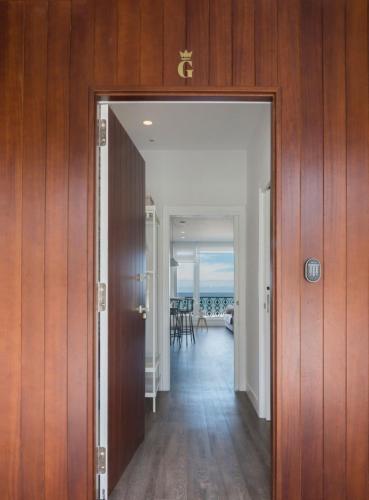 an open door to a hallway with a view of the ocean at Egona - Good Duke in Zarautz