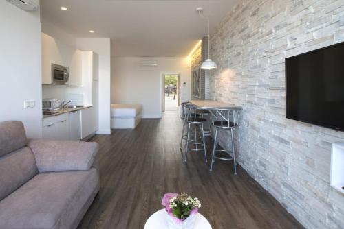 a living room with a couch and a stone wall at Egona - Good Duke in Zarautz