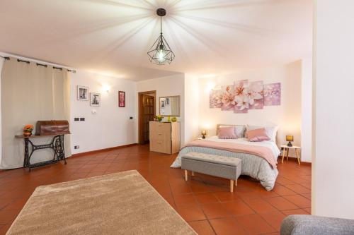 a bedroom with a bed and a chair in it at Il colle dei Frati in Sinalunga