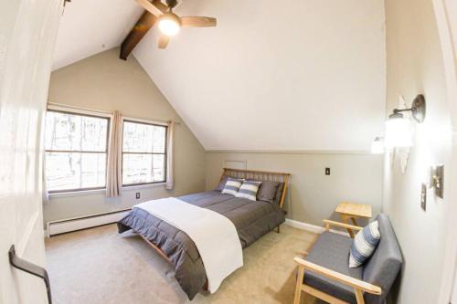 a bedroom with a bed and a couch at A-Frame @ WTG Resort w/ Hot Tub in Mount Torry Furnace