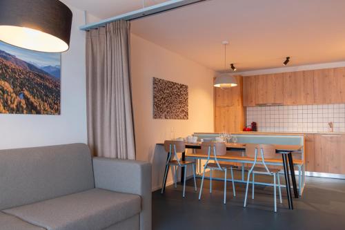 una cucina e una sala da pranzo con tavolo e sedie di SWISSPEAK Resorts Thyon 4 Vallées a Hérémence