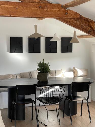 a dining room with a black table and chairs at Casa Familia in La Teste-de-Buch