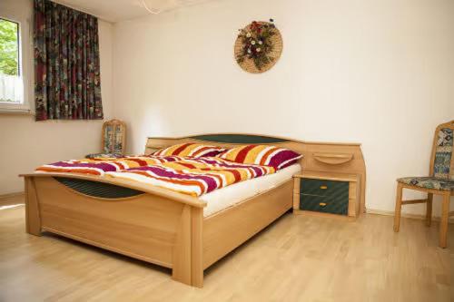 a bedroom with a bed and a table and a chair at Ferienhaus Teufelsmauer in Cattenstedt