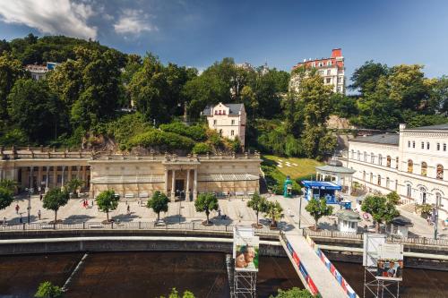 a bridge over a river in a city with buildings at Aqua Marina in Karlovy Vary