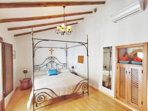- une chambre avec un lit en métal dans une pièce aux murs blancs dans l'établissement Villa Carabeo, à Nerja