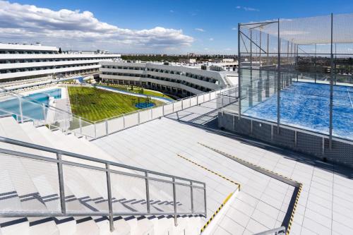 an upper view of a building with a swimming pool at Student Experience Madrid Pozuelo - Luxury Hostel in Pozuelo de Alarcón