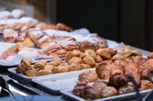 a bunch of different types of pastries on display at Sagitario Playa in Cala Blanca