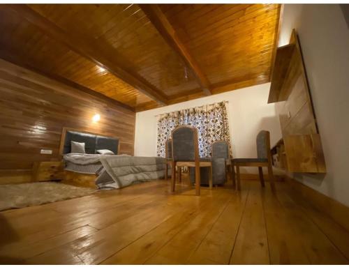a living room with a couch and a bed at JK's The Trout Stream in Gulmarg