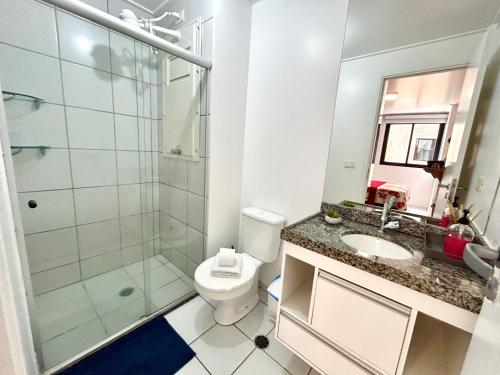 a bathroom with a shower and a toilet and a sink at Apartamento Beira Mar de Pajuçara / Maceió in Maceió