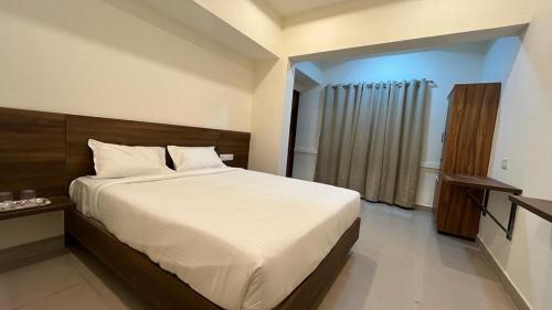 ein Schlafzimmer mit einem großen Bett in einem Zimmer in der Unterkunft OGinn in Chennai
