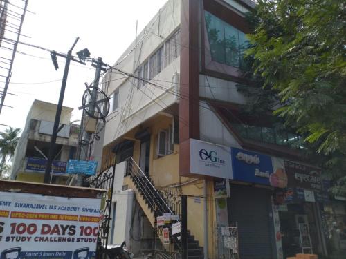 a tall building with signs on the side of it at OGinn in Chennai
