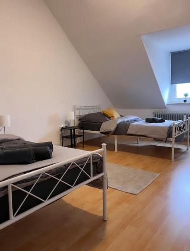 three beds in a room with a attic at Zentral gelegene Appartement. in Gelsenkirchen
