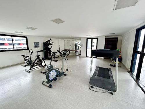 a gym with several exercise bikes and a piano at Apartamento Beira Mar de Pajuçara / Maceió in Maceió