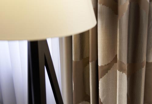 a close up of a lamp next to a window at Sachsenpark-Hotel in Leipzig