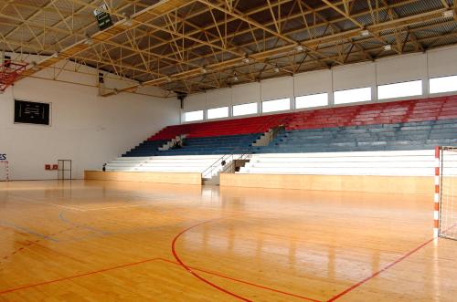 an empty gymnasium with a wooden floor and a basketball court at Hotel Slodes in Belgrade
