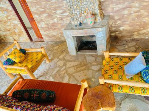 an overhead view of a living room with chairs and a fireplace at Bwindi Neckview Lodge in Buhoma