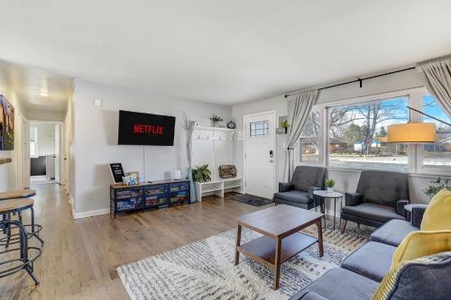 a living room with a couch and a tv at Mulligan Magic - Golf Hot Tub Fire Pit Scenic View in Colorado Springs