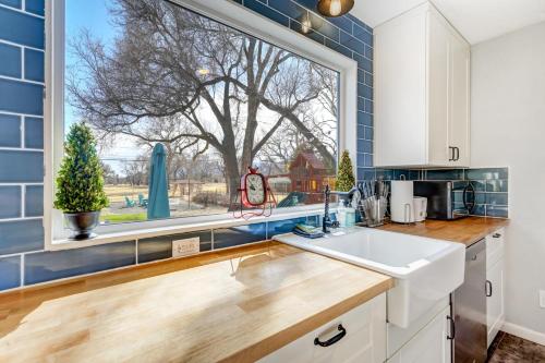 a kitchen with a large window and a sink at Mulligan Magic - Golf Hot Tub Fire Pit Scenic View in Colorado Springs
