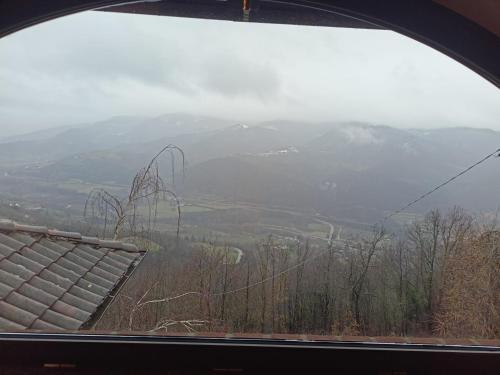 a view of a mountain from a window at Orchidea Selvatica B&B in Levice