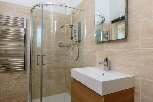 a bathroom with a sink and a shower at No 10 The Towans in St Merryn