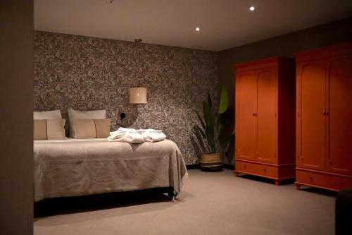 a bedroom with a bed with towels on it at Van der Valk Cuijk - Nijmegen in Nijmegen