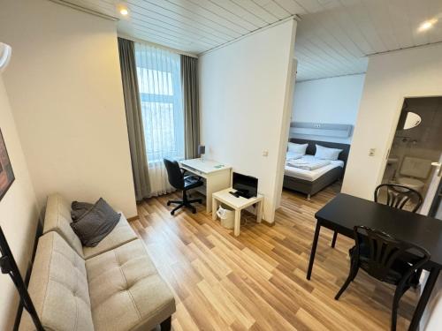 a living room with a couch and a table at Pension Sonnenschein in Halle an der Saale