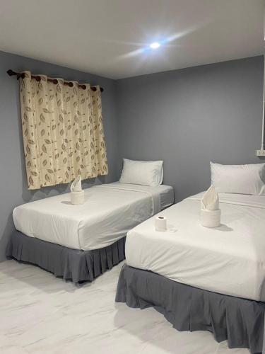2 camas en una habitación con sábanas blancas en Double B House, en Islas Phi Phi
