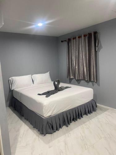 Un dormitorio con una cama con un osito de peluche. en Double B House, en Islas Phi Phi
