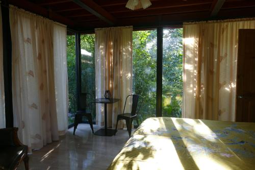 a bedroom with a bed and a large window at Casitas Vista Verde in Bajo Boquete