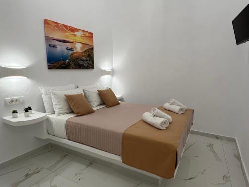 a bedroom with a bed with two towels on it at Villa Pavlina in Karterados