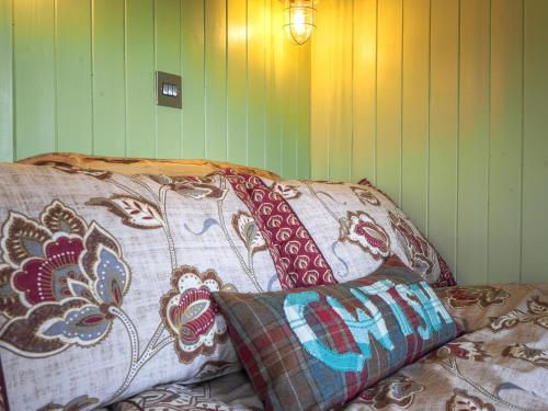 a couple of pillows sitting on top of a bed at Caban y Bugail Abercych in Abercych