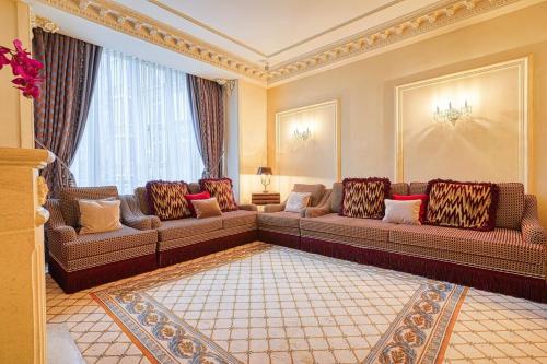 a living room with couches and a large window at Napoleon Suite Champs Elysees in Paris