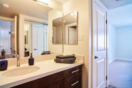 a bathroom with a sink and a large mirror at Marina Magic: Seaside Sanctuary With Marina Views! in Los Angeles