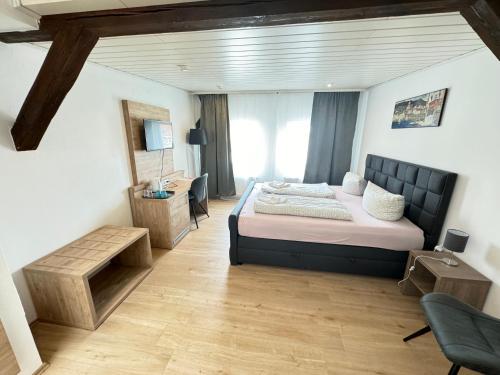 a bedroom with a bed and a desk and a chair at Pension Sonnenschein in Halle an der Saale