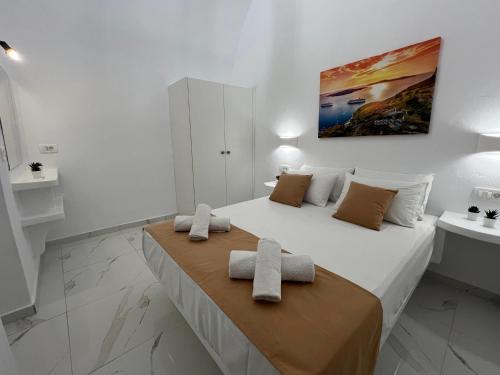 a bedroom with a bed with two towels on it at Villa Pavlina in Karterados