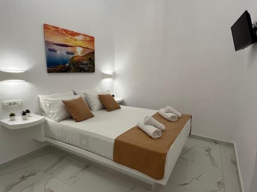a bedroom with a bed with towels on it at Villa Pavlina in Karterados