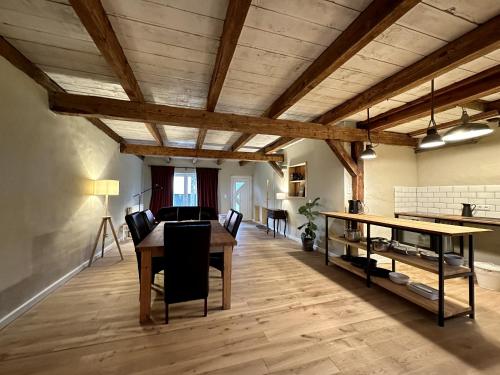 a dining room with wooden ceilings and a table and chairs at Cavalan Ranch in Wardow