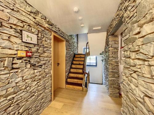a hallway with a stone wall and a staircase at Gîte à Esneux - A La Belle Epoque d'Esneux in Esneux