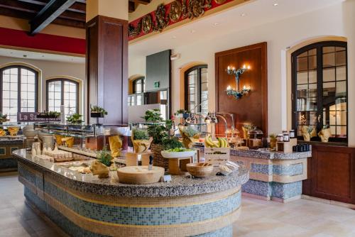 a lobby with a counter with food on it at Hilton Molino Stucky Venice in Venice